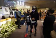  ?? DAVID J. PHILLIP — THE ASSOCIATED PRESS ?? Mourners pass by the casket of George Floyd during a public visitation for Floyd at the Fountain of Praise church Monday, June 8, in Houston.