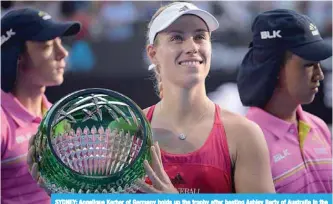  ?? — AFP ?? SYDNEY: Angelique Kerber of Germany holds up the trophy after beating Ashley Barty of Australia in the women’s singles final at the Sydney Internatio­nal tennis tournament in Sydney yesterday.