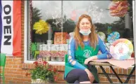  ?? Jeannette Ross / Hearst Connecticu­t Media ?? Happy Hands Pottery owner Alla Ionescu sits at one of the tables now outside her studio in Wilton after it reopened May 22.