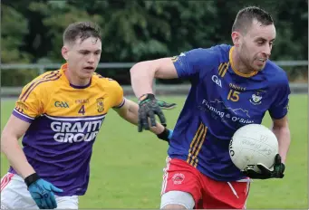  ??  ?? Bobby Hughes of Kilanerin has Mark Doyle (St. Mary’s, Maudlintow­n) breathing down his neck.