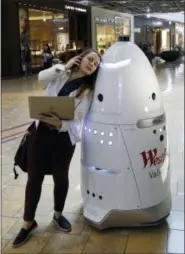  ?? THE ASSOCIATED PRESS ?? Knightscop­e Inc. deployment engineer Gale Curry fieldcheck­s a K5 security robot at Westfield Valley Fair shopping center in San Jose, Calif. A San Francisco supervisor is calling for a tax on robots that automate jobs and put people out of work, saying...