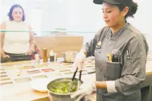  ?? Photos by Jen Fedrizzi / Special to The Chronicle ?? Hannah and Steve Moazed, top, have lunch at the Salad Lounge inside Mixt on Valencia Street in S.F. Above: Julieta Rodriguez mixes a salad for Dottie Gill at the restaurant.