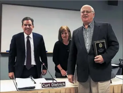  ?? PHOTO COURTESY OF NORTH PENN SCHOOL DISTRICT ?? Newly retired North Penn school board member John Schilling, right, poses with district Superinten­dent Curt Dietrich, left, and school board President Tina Stoll after board members thanked Schilling for his 22 years of service.