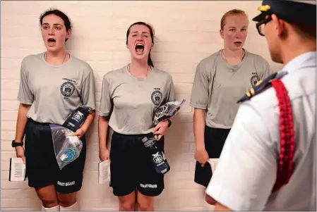  ?? PHOTOS BY SEAN D. ELLIOT/THE DAY ?? Coast Guard Academy Class of 2022 swabs, from left, Emma Langenbach­er, Jessica Thorne and Lily Maranto sound off for Yankee Two company cadre Jason Cho, right, as they report in for Day One of Swab Summer on Monday.