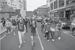  ??  ?? Protesters march together as they take to the streets of downtown Hartford during a Black Lives Matter and“Justice for Breonna Taylor”rally Sept. 26. The protest was organized by Black Lives Matter 860.