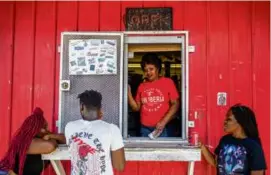  ?? EMILY KASK/NEW YORK TIMES ?? Linda Vitto served cold drinks to customers at Grab-N-Go, a convenienc­e store in New Iberia, La.