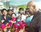  ?? — AFP ?? Former US boxer Mike Tyson is greeted with roses during his visit to a local school on the sidelines of India’s first global Mixed Martial Arts (MMA) league, in Mumbai yesterday.