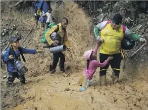  ?? MIGRANTS Fernando Vergara Associated Press ?? from Ecuador cross the Darien Gap in hopes of reaching the U.S.