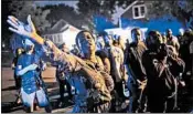  ?? AARON LAVINSKY/STAR TRIBUNE ?? Minneapoli­s NAACP President Leslie Badue leads a prayer in response to the Saturday police killing of a black man.