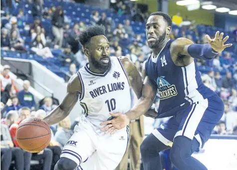  ?? PHOTOS BY JULIE JOCSAK/ STANDARD STAFF ?? Omar Strong of the Niagara River Lions tries to get the ball past Antoine Mason of the Halifax Hurricanes in basketball action at Meridian Centre in St. Catharines Wednesday night.