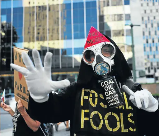  ?? Picture: JEWEL SAMAD/AFP ?? CASH BEFORE CLIMATE: Activists protest in New York on Thursday against US President Donald Trump’s decision to pull out of the 195-nation Paris climate accord. Trump earlier announced America was ‘getting out’ of a deal he said imposed ’draconian’...