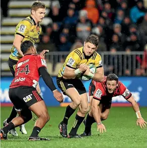  ??  ?? Hurricanes first five-eighth Beauden Barrett is swamped by Crusaders players during their match on May 25. The Crusaders won 24-13 to end the Hurricanes’ 10-game winning streak. GETTY IMAGES
