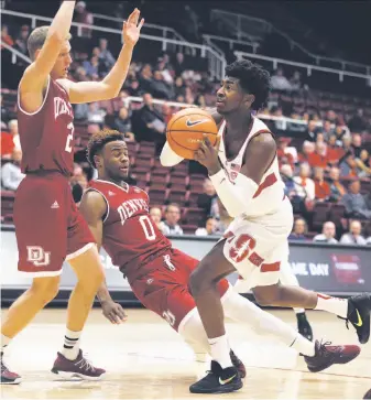  ?? Ben Margot / Associated Press ?? Stanford point guard Daejon Davis drives past Denver’s Ade Murkey (0) and Joe Rosga.