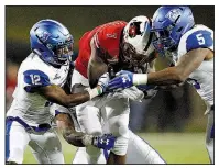  ?? Arkansas Democrat-Gazette/THOMAS METTHE ?? Wide receiver Omar Bayless (center) fights for extra yardage against Georgia State defenders Tyler Gore (12) and Chase Middleton. See more photos at arkansason­line.com/galleries