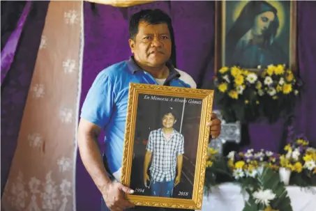  ?? Alfredo Zuniga / Associated Press ?? Alvaro Gomez holds a portrait of hi son, Alvaro, who was killed during a student-led protest against the government in Masaya.