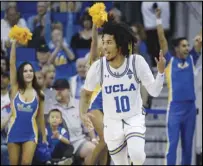  ?? Associated Press ?? THREES UP UCLA guard Tyger Campbell celebrates after making a 3-pointer during the second half against Utah in Los Angeles on Sunday. The Bruins won 73-57 to finish a Pac-12 weekend sweep.