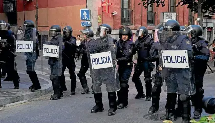  ?? AP ?? Riot police stand by during a small anti-Nato protest in Madrid yesterday as heads of state meet nearby.
