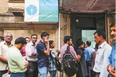  ?? Bloomberg ?? Customers queue to withdraw cash at a State Bank of India branch in Mumbai last November 18.