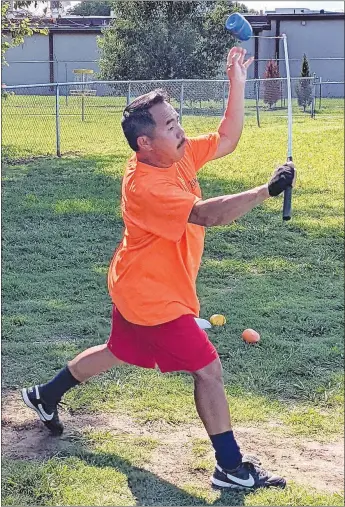  ?? Westside Eagle Observer/RANDY MOLL ?? Keng Vang throws a top as he practices before a game of Tuj Lub in Gentry City Park on Aug. 30.