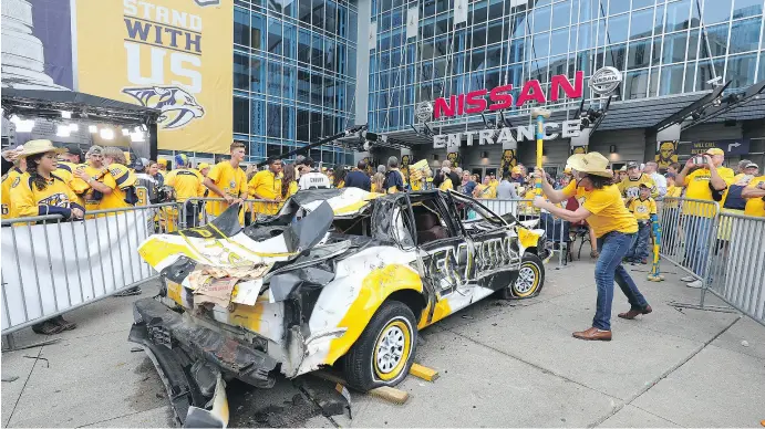  ?? BRUCE BENNETT / GETTY IMAGES FILES ?? There is no question the excitement seen from the Predators fans was widely noticed across the NHL. A Nashville fan hits a Pittsburgh Penguins car with a sledgehamm­er prior to Game 4 of the 2017 NHL Stanley Cup final at the Bridgeston­e Arena in...