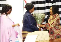  ?? ?? First Lady Dr Auxillia Mnangagwa receives flowers from Mrs Luisa Filipe Lucio, wife of Mozambican Ambassador to Zimbabwe, and Mrs Umutesi Katushabe Julian from Rwanda, who were representi­ng their colleagues during their visit to console Dr Mnangagwa following the loss of her grandson