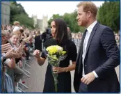  ?? ?? The Prince and Princess of Wales with the Duke and Duchess of Sussex at Windsor; above, Meghan is presented with flowers