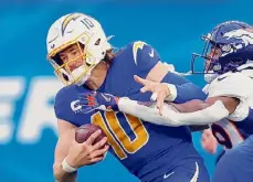  ?? ?? Chargers QB Justin Herbert is sacked by Broncos CB Ja’Quan McMillian on Dec. 10. He suffered a broken finger in the game, ending his season.
6. NEW YORK GIANTS (6-11):
