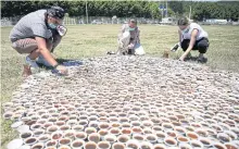  ??  ?? Artist Aida Sehovic, centre, installs her collection of ceramic fildzan cups.