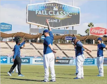  ?? JAE C. HONG/AP ?? Several members of the Dodgers loosen up before Game 7 of the World Series against the Astros on Wednesday night.