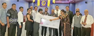  ?? Photo: Vodafone Fiji ?? Lions Club president Pradeep Chandra (front, left), and Vodafone ATH Fiji Foundation executive Ambalika Devi (front, right), during the cheque handover with members of the Lions Club in Ba.