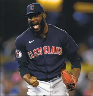  ?? Ronald Martinez Getty Images ?? ENYEL DE LOS SANTOS of the Guardians erupts after nailing down the save in a 2-1 win over the Dodgers. He struck out Justin Turner with Trea Turner on second in the 10th inning to end it.