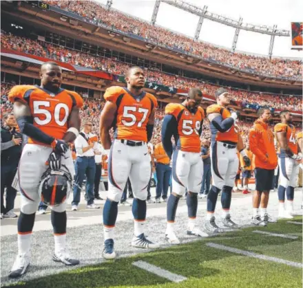  ?? Justin Edmonds, Getty Images ?? Broncos players stand during the national anthem before the Oct. 1 game against the Oakland Raiders.