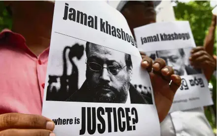  ??  ?? Making a stand: Members of the Sri Lankan web journalist associatio­n holding placards with the image of Khashoggi during a demonstrat­ion outside the Saudi Embassy in Colombo.