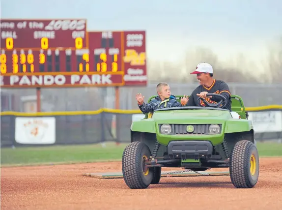  ?? Hyoung Chang, Denver Post file ?? Rocky Mountain coach Scott Bullock and his son, Tagg, sweep the field after a victory in 2011.