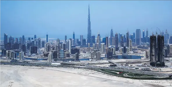  ?? MARWAN NAAMANI/AFP/GETTY IMAGES ?? The global supply of sand is dwindling to the point that even a desert city like Dubai had to import the sand used in the Burj Khalifa, above, from Australia. Canadian sand firms are profiting from the demand, but industry players are warning about the price that will be paid by everyone from the supply chain, from builders to homeowners.