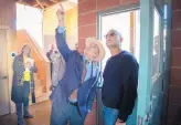  ??  ?? Santa Fe Mayor Alan Webber, left, tours the home that Michael Golino designed and built in the Baca Street portion of the Santa Fe Railyard.