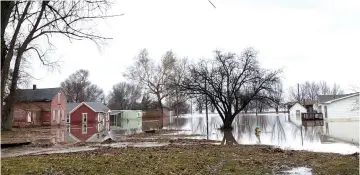  ??  ?? Homes sit in flood waters after leaving casualitie­s and causing hundreds of millions of dollars in damages, with waters yet to crest in parts of the US midwest, in Peru, Nebraska, US. — Reuters photo