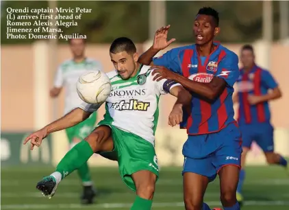  ??  ?? Qrendi captain Mrvic Petar (L) arrives first ahead of Romero Alexis Alegria Jimenez of Marsa. Photo: Domenic Aquilina