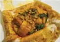  ??  ?? Siddique’s curried mixed-vegetable roti is one of Vena’s Restaurant’s top sellers.