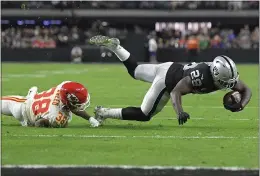  ?? DAVID BECKER — THE ASSOCIATED PRESS ?? Kansas City Chiefs cornerback L’Jarius Sneed (38) tackles Las Vegas Raiders running back Josh Jacobs (28) during the first half Sunday in Las Vegas.