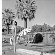 ??  ?? ABOVE: Sally as a baby in her mother’s lap, and taking the plunge into the pool while on a holiday in Palm Springs. LEFT: With halfsister Princess, her mother and the towering Jock Mahoney, whom she feared from the start.