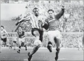  ?? PA FILE VIA AP ?? In this file photo dated Jan.31, 1987, Coventry City’s Cyrille Regis, left, and Manchester United’s John Sivebaek, in Manchester, England. Monday. Cyrille Regis, a pioneer for black footballer­s in England who endured racist abuse while forging a career...