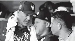  ?? DUANE BURLESON/AP ?? Yankees manager Aaron Boone, left, talks with catcher Gary Sanchez on Thursday.