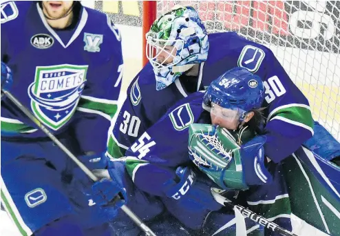  ?? ALEX COOPER/OBSERVER-DISPATCH FILES ?? Comets goalie Thatcher Demko catches teammate Jonathan Dahlen on April 27 at the Utica Memorial Auditorium. The Comets are fourth in the AHL’s North Division with a 24-19-3-2 record.