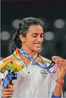  ?? — PTI ?? P.V. Sindhu stands on the podium after receiving the bronze medal in women’s singles badminton event at the Olympics in Tokyo on Sunday.