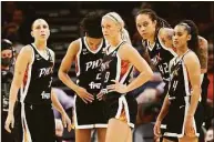  ?? Christian Petersen / Getty Images ?? From left, Diana Taurasi, Brianna Turner, Sophie Cunningham, Brittney Griner and Skylar Diggins-Smith of the Phoenix Mercury stand on the court during the second half in Game 2 of the 2021 WNBA Finals against the Chicago Sky in October.