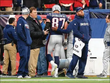  ?? ADAM GLANZMAN / GETTY IMAGES ?? New England star tight end Rob Gronkowski gets helped off the field after being shaken up on a helmet-to-helmet hit during the victory over Jacksonvil­le in the AFC Championsh­ip game Sunday.