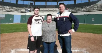  ?? CITIZEN PHOTO BY BRENT BRAATEN ?? Jake McLeod, left, gathers at home plate at Citizen Field with his mother Carrie and Paul Wilson of the Northland Dodge Prince George Senior Baseball League. The league is donating all proceeds from its home-run derby tonight and from Sunday’s all-star...