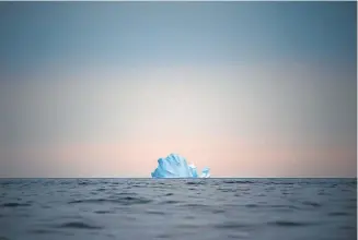  ?? Felipe Dana, The Associated Press ?? A huge iceberg floats away last week near Kulusuk, Greenland.