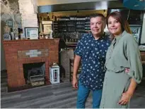  ?? AMY BETH BENNETT/SOUTH FLORIDA SUN SENTINEL ?? Co-owners Frank and Yady Rodriguez with their unusual chimney in the dining room at The Chimney House, celebratin­g 10 years in downtown Fort Lauderdale.